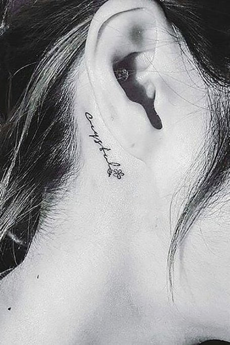 Tatuaggio con scritte dietro l'orecchio